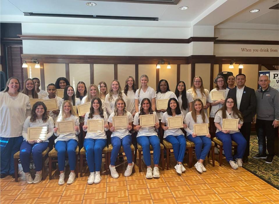 CNA graduates include, front row, Madison Rodgers (WG), Jocelyn Bowlsby (WG), Gretta Yingst (WG), Macey Jermier (DCG), Sayler Ribich (DCG), Amy Diaz (Perry), Parker Creighton (OHS), Jami Fogleson (Adult). Back row, Katie Tuel (Instructor), Lauren Rodgers (WG), Minasey Twelde (Perry), Diana Okubay (Perry), Keilayla Gregory (WG), Avery Bahrenfuss (Panorama), Aliyah Fortner (Panorama), Paisley Sutton (ADM), Ashley Downing (ADM), Derika Andrus (DCG), Jillian Olmstead (Madrid), Jocelyn Bowlsby (WG), Dsheka Maggett (Adult), Leslie Ruacho (Adult), Lydia James (Panorama), Elizabeth Meurer (Adult), Connie Saenz (LCAN Advisor), Eddie Diaz (VanKirk Career Academy Site Director), Tom Lipovac (Career Advantage Advisor).