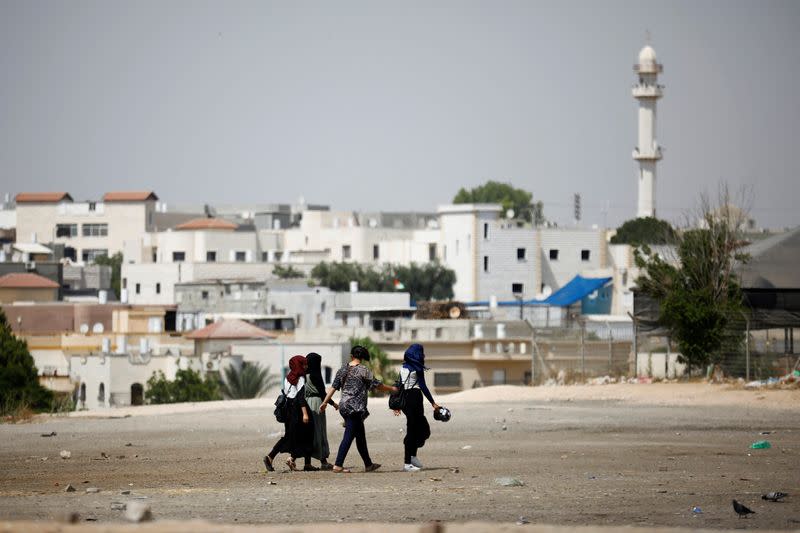 FILE PHOTO: Girls walk on the outskirts of the Bedouin city of Rahat