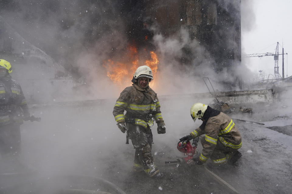 Firefighters extinguish a fire after a Russian attack on residential neighbourhood in Kharkiv, Ukraine Saturday, Feb. 10, 2024. Seven people including three children were killed in the Russian drone attack, said the city administration. (AP Photo/Andrii Marienko)