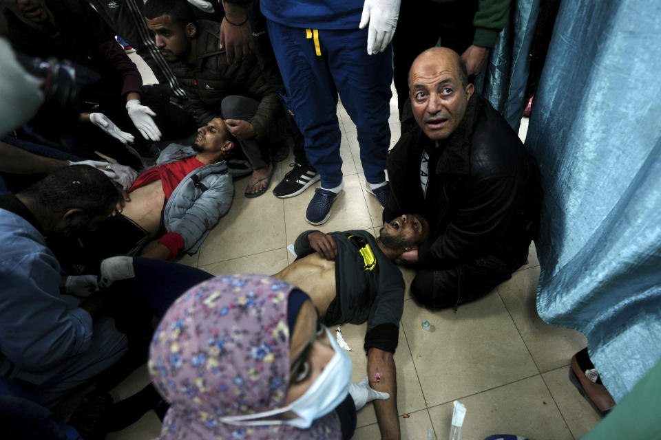 Palestinians wounded in the Israeli bombardment of the Gaza Strip are brought to the hospital in Deir al Balah, Gaza Strip, on Sunday, Dec. 24, 2023. (AP Photo/Adel Hana)