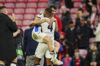 Atalanta's Isak Hien, front, and Matteo Ruggeri celebrate after beating 3-0 Liverpool during the Europa League quarter final first leg soccer match at the Anfield stadium in Liverpool, England, Thursday, April 11, 2024. (AP Photo/Jon Super)