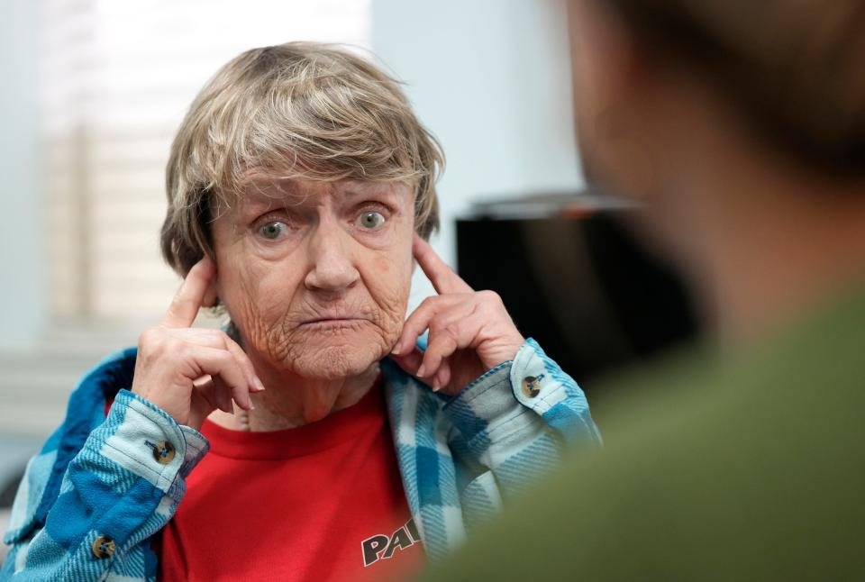 Sue Smith talks to Dr. Kailey Murphy during an examination for hearing aids at Hearing and Brain Centers of America. Smith still needs cleaning supplies and smoke detectors that flash and other accessibility devices.