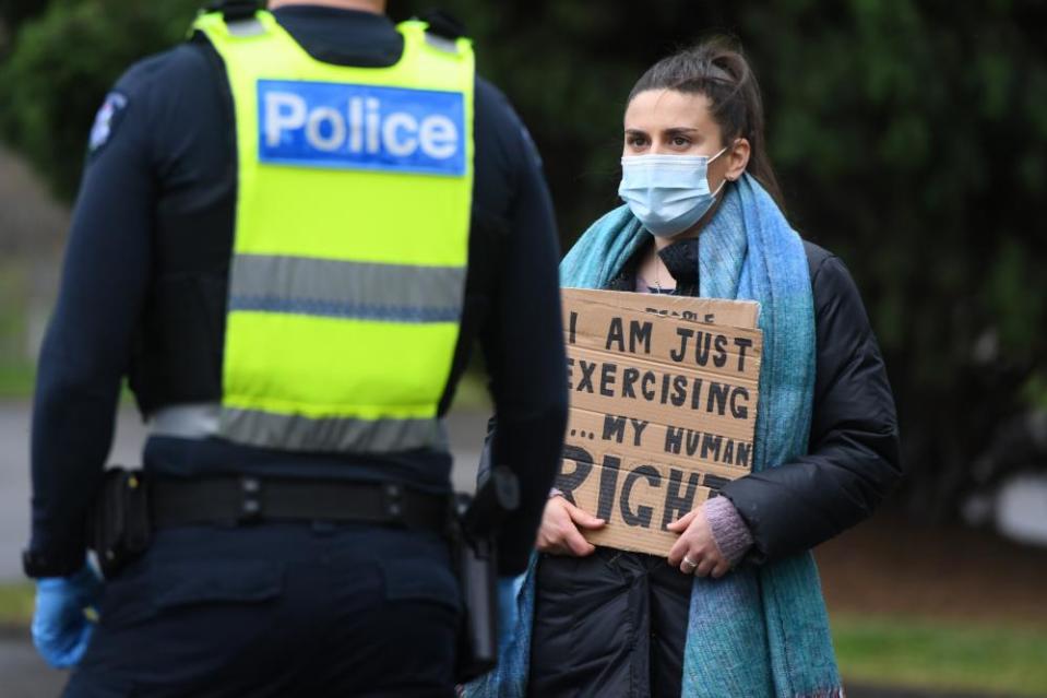 A woman speaks to police during an anti-lockdown protest.