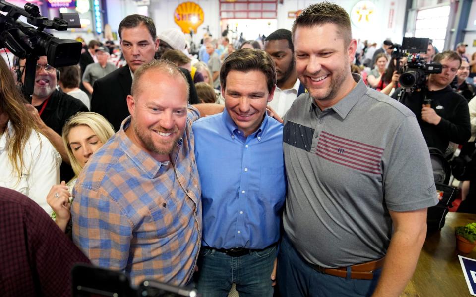 Ron DeSantis with audience members during a fundraising picnic in Sioux Centre, Iowa, also on Saturday - Charlie Neibergall/AP