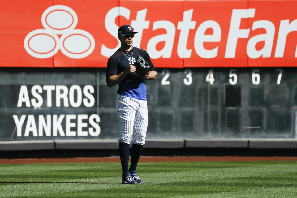 New York Yankees left fielder Giancarlo Stanton waits for balls in the outfield during batting practice before Game 3 of baseball's American League Championship Series against the Houston Astros, Tuesday, Oct. 15, 2019, in New York. (AP Photo/Matt Slocum)