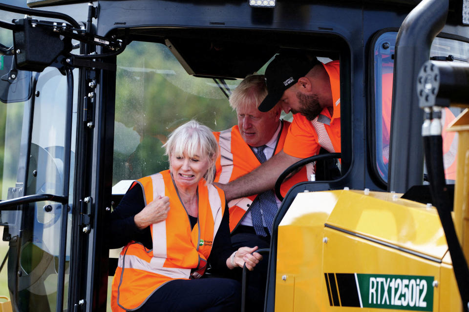 British Prime Minister Boris Johnson and Culture Secretary Nadine Dorries visit Henbury Farm in North Dorset, where Wessex Internet are laying fibre optics in the field, in Dorset, Britain, August 30, 2022. Ben Birchall/Pool via REUTERS     TPX IMAGES OF THE DAY