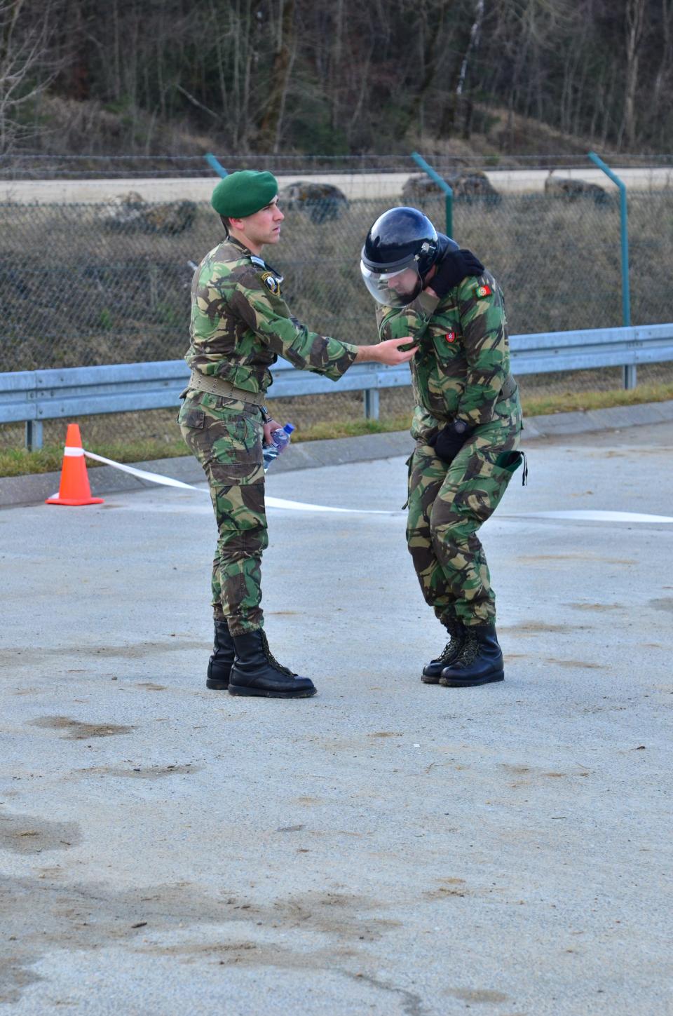 An image of two men in army fatigues demonstrating proper technique during a fire phobia training.
