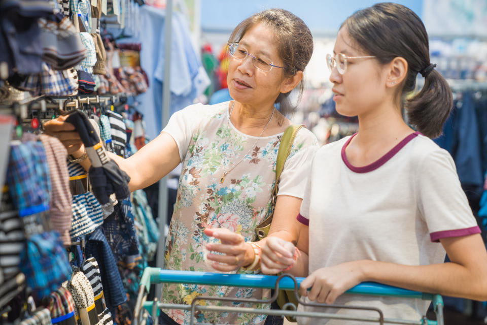 Asian family mother and teenage girl enjoy shopping, illustrating a story on Assurance Package.