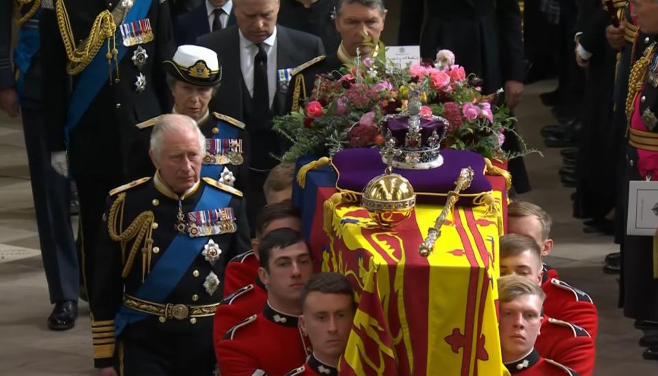 King Charles next to casket