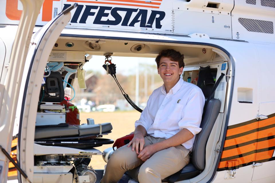 Knoxville Catholic High School junior Andrew Dreiser looks comfortable exploring the interior of UT LIFESTAR helicopter.