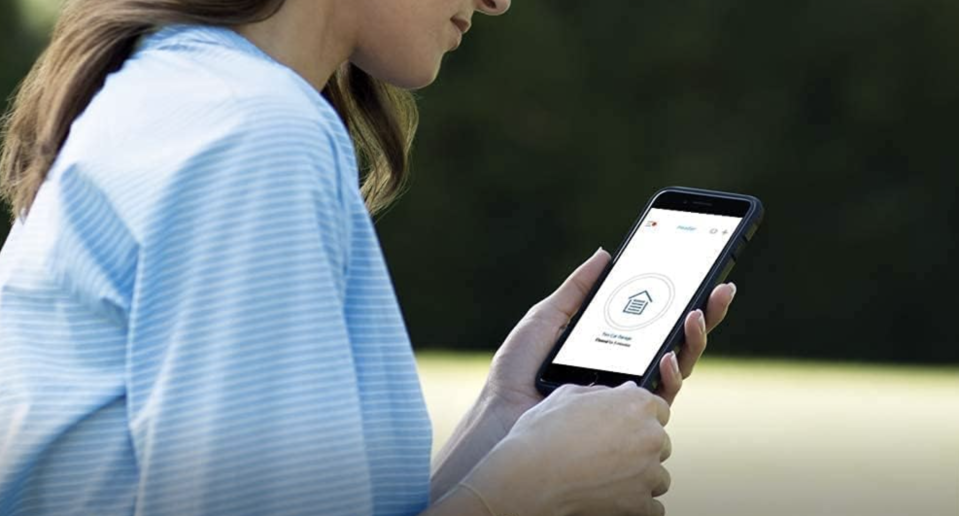 woman using the Chamberlain smart garage control system app