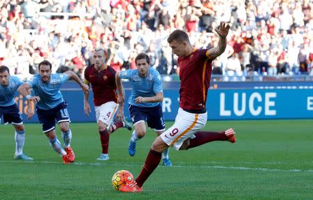 AS Roma's Edin Dzeko shoot and scores a penalty kick against Lazio's during their Serie A soccer match at Olympic stadium in Rome, Italy, November 8, 2015. REUTERS/Alessandro Bianchi