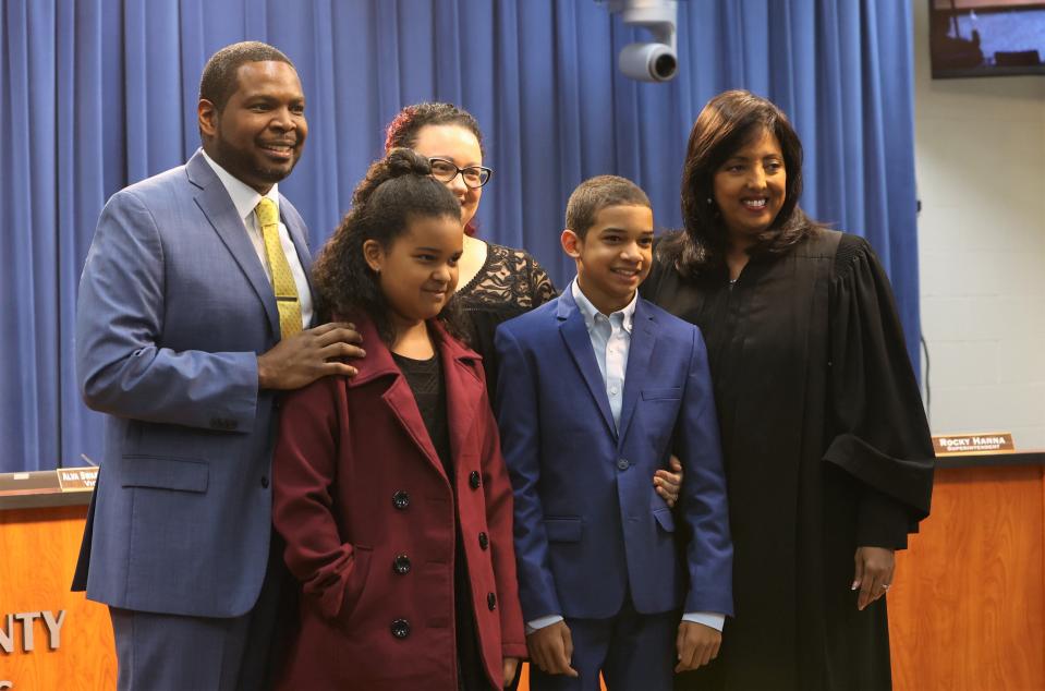 Newly elected school board member Marcus Nicolas, left, poses for a photo with his family and Judge Nina Ashenafi Richardson at a Leon County School Board meeting on Tuesday, Nov. 22, 2022.