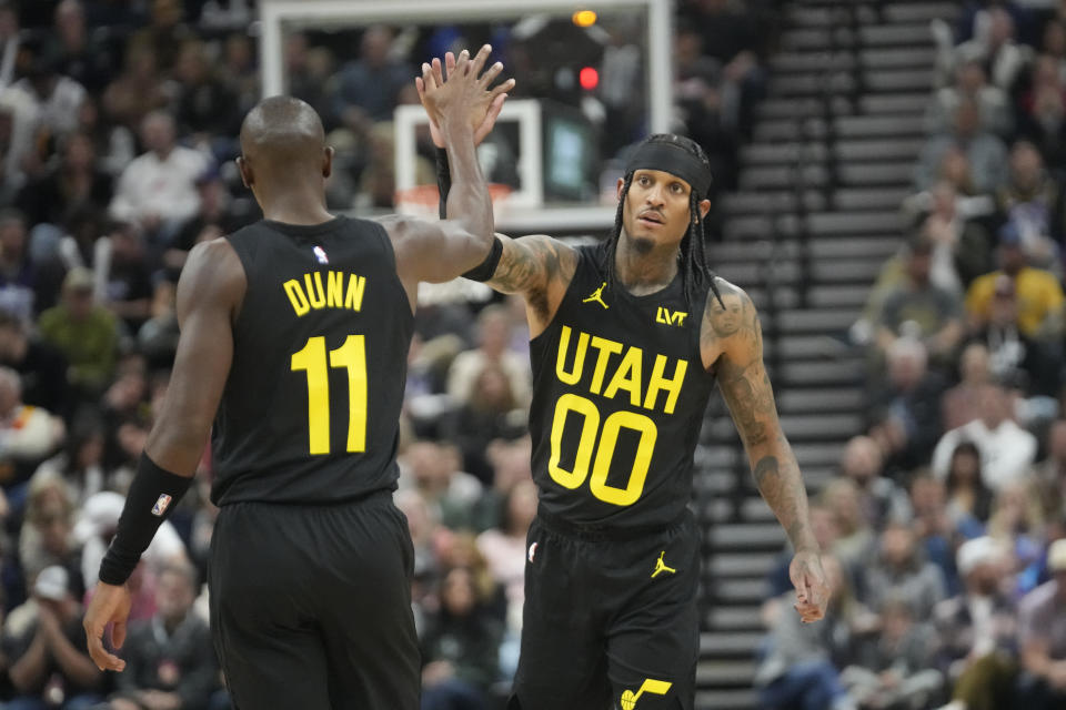 Utah Jazz's Jordan Clarkson (00) and Kris Dunn (11) celebrate during the first half of an NBA basketball game against the Los Angeles Clippers, Friday, Oct. 27, 2023, in Salt Lake City. (AP Photo/Rick Bowmer)