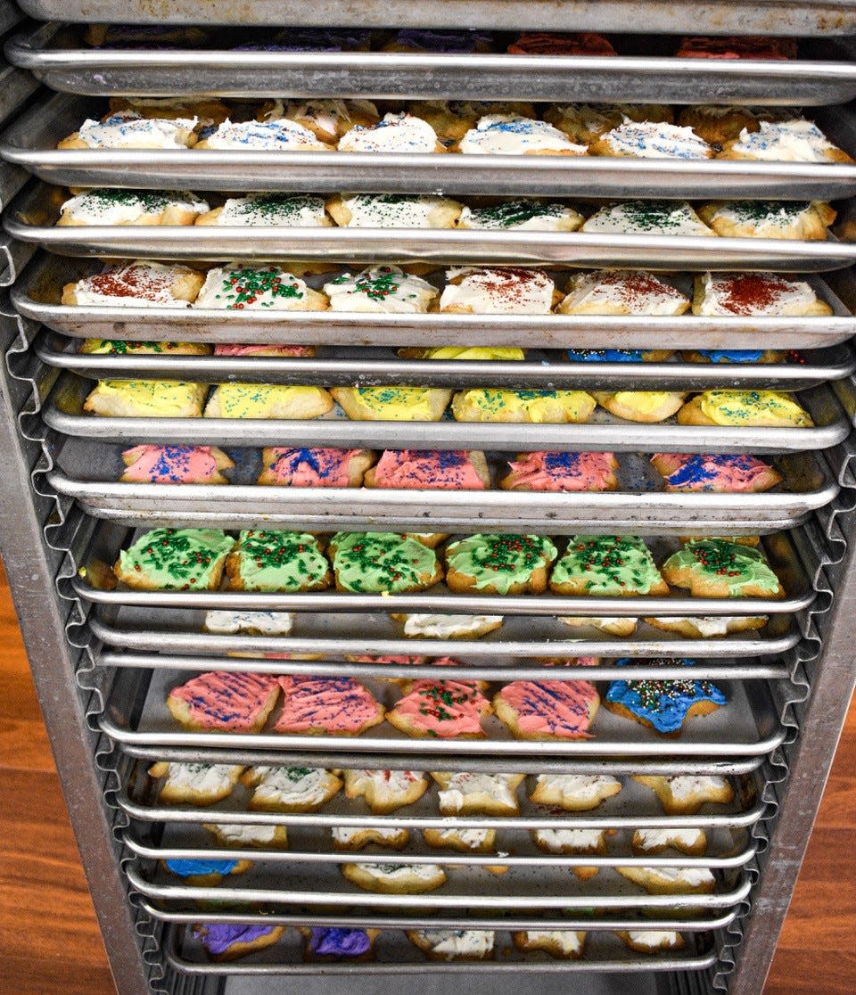 Pans of frosted cookies wait to be boxed and delivered for Operation Cookie Drop.