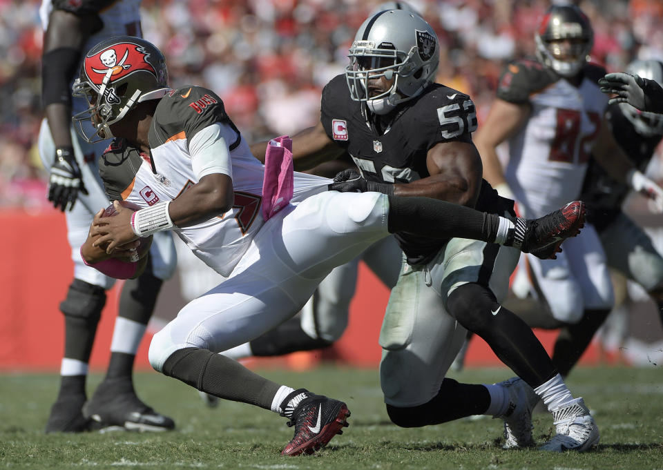 FILE - In this Oct. 30, 2016, file photo, Oakland Raiders defensive end Khalil Mack (52) sacks Tampa Bay Buccaneers quarterback Jameis Winston (3) during the second half of an NFL football game in Tampa, Fla. The Chicago Bears have acquired star pass rusher Khalil Mack from the Raiders on Saturday, Sept. 1, 2018, in a massive trade that sends two first-round draft picks to Oakland. A person with direct knowledge of the trade told The Associated Press that Oakland will get first-round selections in 2019 and 2020, a sixth-rounder next year and a third-rounder in 2020. Oakland also included its second-round selection in 2020. The person spoke on condition of anonymity because the trade had not been announced. (AP Photo/Phelan M. Ebenhack, File)