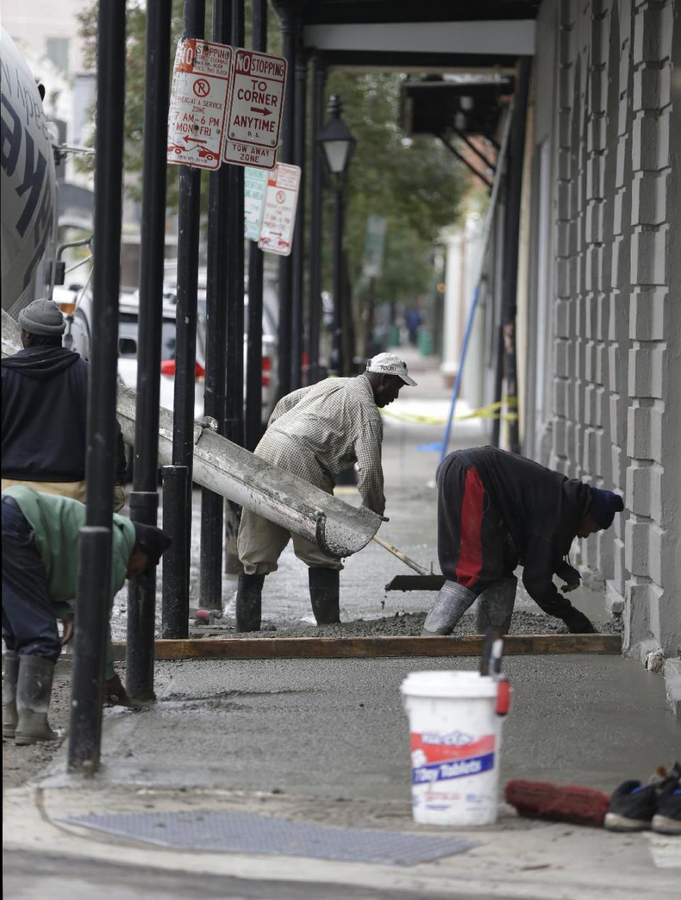 This Jan. 15, 2013 photo shows workers pouring a new sidewalk on Royal Street in the French Quarter section of in New Orleans. With the Super Bowl in New Orleans Feb. 3 and Mardi Gras falling just nine days later, the city is gearing up for a massive celebration and influx of tourists that locals are calling "Super Gras." (AP Photo/Gerald Herbert)