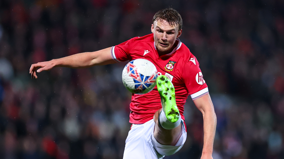 Sam Dalby reaching out for the ball while playing for Wrexham.