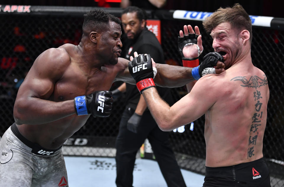 LAS VEGAS, NEVADA - MARCH 27: (L-R) Francis Ngannou of Cameroon punches Stipe Miocic in their UFC heavyweight championship fight during the UFC 260 event at UFC APEX on March 27, 2021 in Las Vegas, Nevada. (Photo by Jeff Bottari/Zuffa LLC)