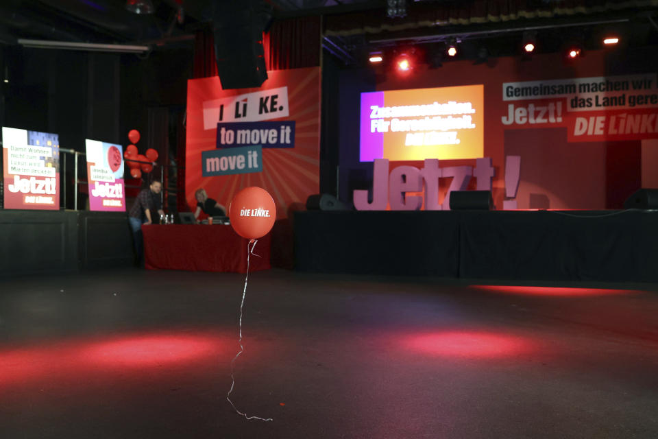 A balloon floats through the hall of the election party of Die Linke in the Karl-Liebknecht-Haus after everyone has left in Berlin, Sunday, Sept. 26, 2021. Exit polls show the center-left Social Democrats in a very close race with outgoing Chancellor Angela Merkel’s bloc in Germany’s parliamentary election, which will determine who succeeds the long-time leader after 16 years in power. (Jan Woitas/dpa via AP)