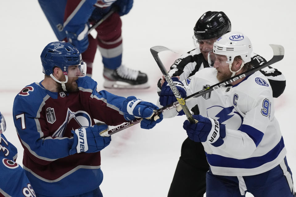 Tampa Bay Lightning center Steven Stamkos (91) clashes with Colorado Avalanche defenseman Devon Toews (7) during the first period in Game 2 of the NHL hockey Stanley Cup Final Saturday, June 18, 2022, in Denver. (AP Photo/David Zalubowski)