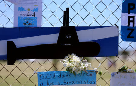A bouquet of flowers and banners in support of the 44 crew members of the missing at sea ARA San Juan submarine are placed on a fence outside an Argentine naval base in Mar del Plata, Argentina November 25, 2017. The banner below reads "God, give strenght to the submariners". REUTERS/Marcos Brindicci
