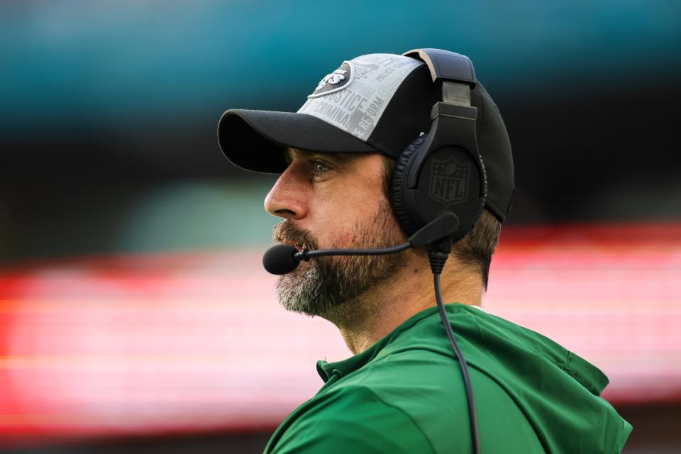 Dec 17, 2023; Miami Gardens, Florida, USA; New York Jets quarterback Aaron Rodgers (8) looks on from the sideline against the Miami Dolphins during the fourth quarter at Hard Rock Stadium. Mandatory Credit: Sam Navarro-USA TODAY Sports