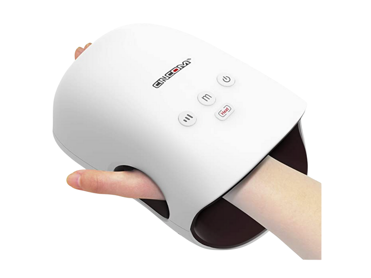 White hand massager on a woman's hand