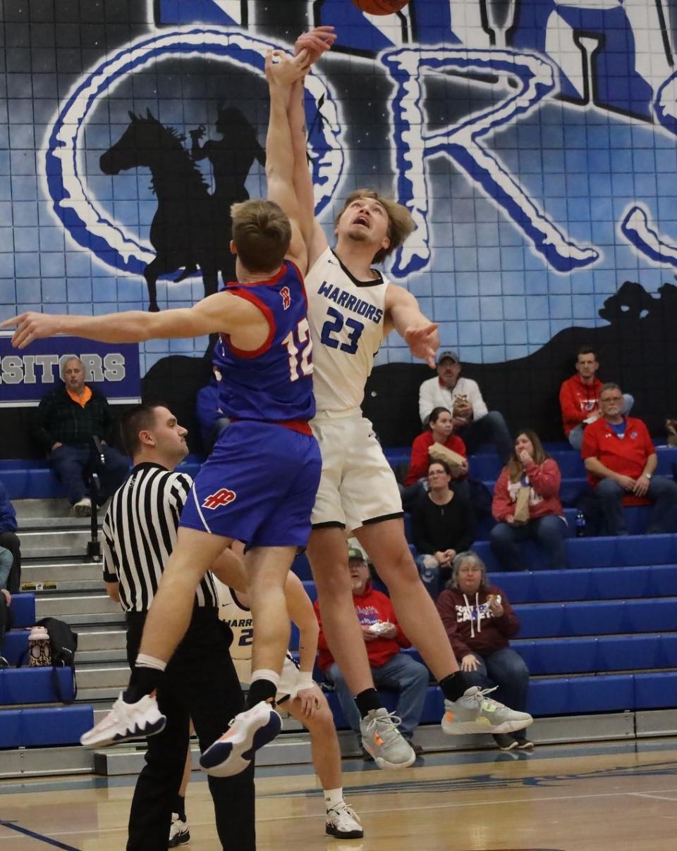 Buckeye Trail senior Garrett Burga (23) battles with Fort Frye's Clayton Miller (12) on the opening tip-off of Friday's OVAC matchup in Old Washington.