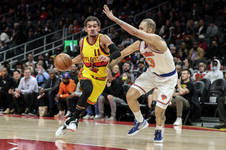 Atlanta Hawks guard Trae Young (11) drives to the basket as New York Knicks guard Evan Fournier (13) defends during the first half of an NBA basketball game Saturday, Jan. 15, 2022, in Atlanta. (AP Photo/Butch Dill)