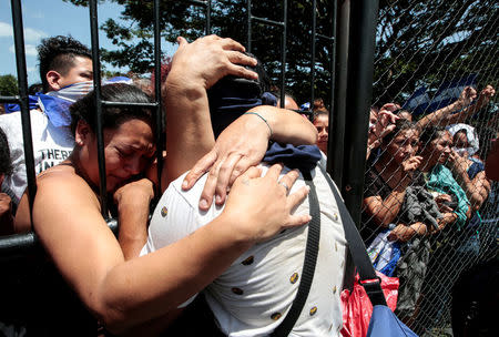 Relatives embrace an university student who was freed after being trapped overnight in Divine Mercy Catholic Church where they took shelter as pro-government gunmen shot at them at the National Autonomous University of Nicaragua (UNAN), in Managua, Nicaragua July 14, 2018. REUTERS/Oswaldo Rivas 