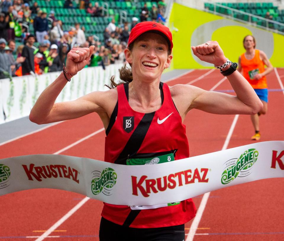 Carrie Dimoff celebrates as she wins the women's title during the Eugene Marathon in Eugene Sunday.