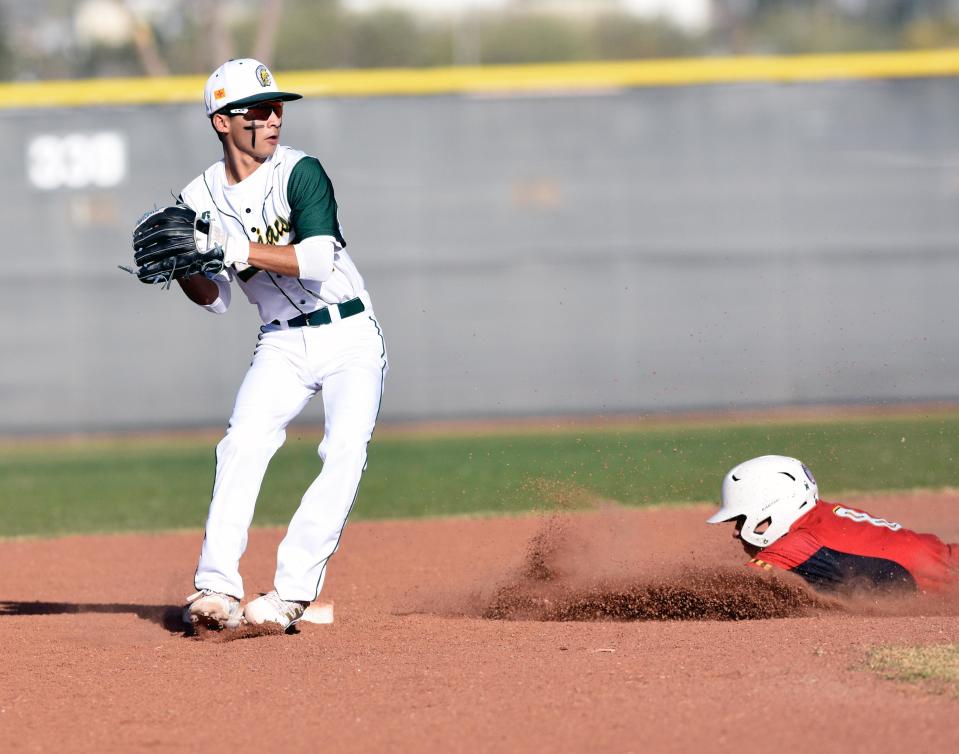 Mayfield second baseman Anthony Carrillo turns a double play as the Trojans took on the Centennial Hawks on Friday night.