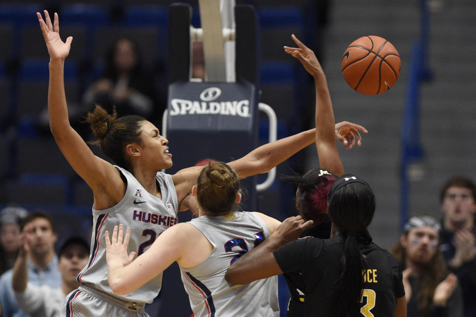 Connecticut's Olivia Nelson-Ododa , left, blocks a shot by Wichita State's Mariah McCully during the second half of an NCAA college basketball game Thursday, Jan. 2, 2020, in Hartford, Conn. (AP Photo/Jessica Hill)