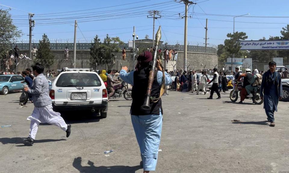 A member of Taliban forces inspects the area outside Hamid Karzai International Airport in Kabul, on Monday.