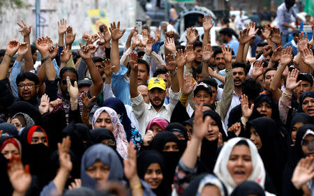 Pakistani Shi'ite supporters of Imamia Students Organization (ISO) rise their hands as they chant slogans to condemn the Friday's blast at vegetable market in Quetta, during a protest in Karachi, Pakistan April 14, 2019. REUTERS/Akhtar Soomro