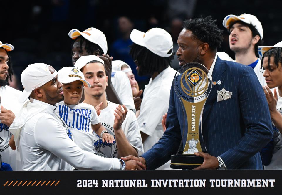 Apr 4, 2024; Indianapolis, IN, USA; Seton Hall Pirates head coach Shaheen Holloway is presented with the trophy after defeating the Indiana State Sycamores at Hinkle Fieldhouse. Mandatory Credit: Robert Goddin-USA TODAY Sports