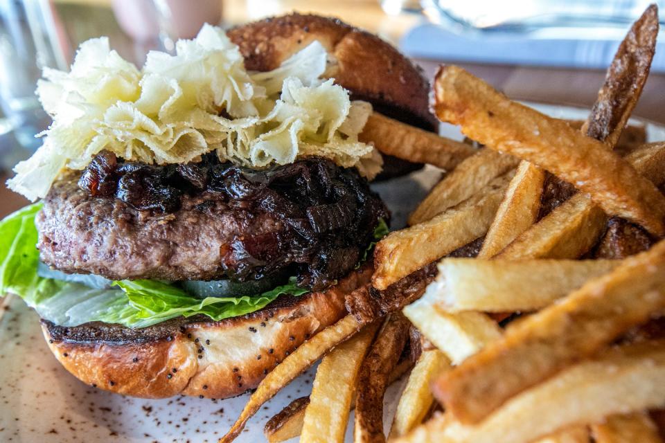 The Coeur lamb burger is made with rosemary onion jam, Tête de Moine, lettuce and pickles.
