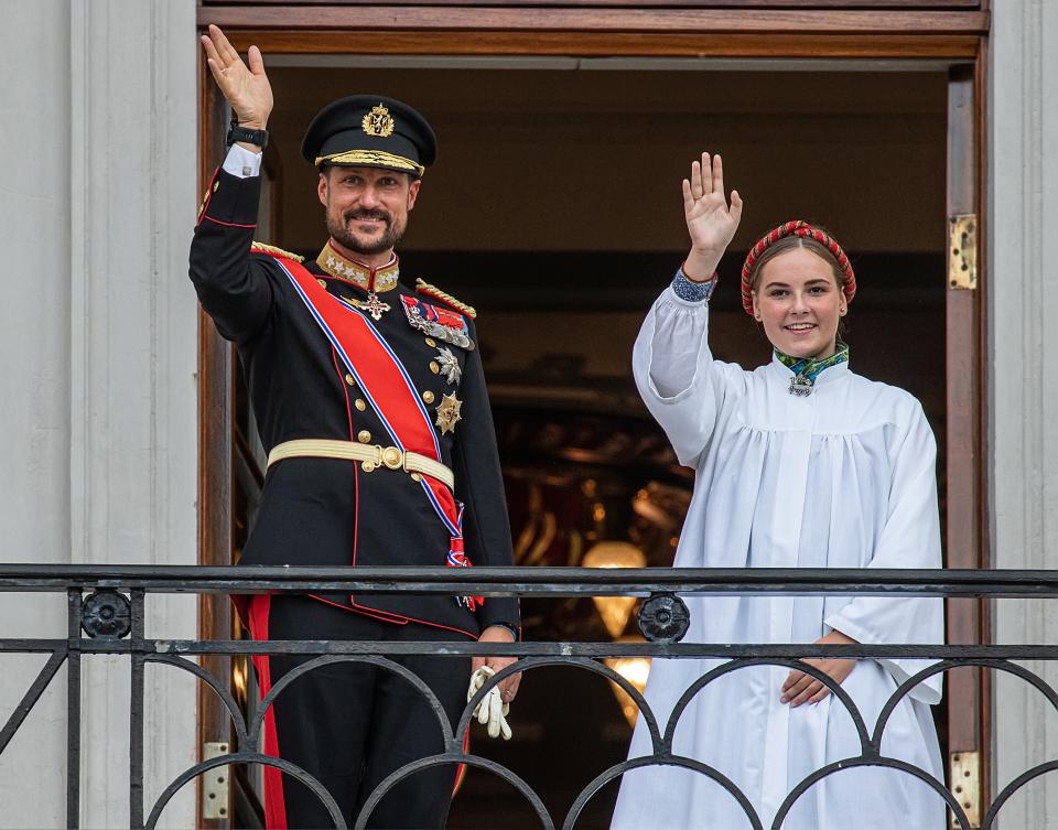 Prince Haakon and Princess Ingrid Alexandra wave to well-wishers outside the Royal Palace in Oslo.