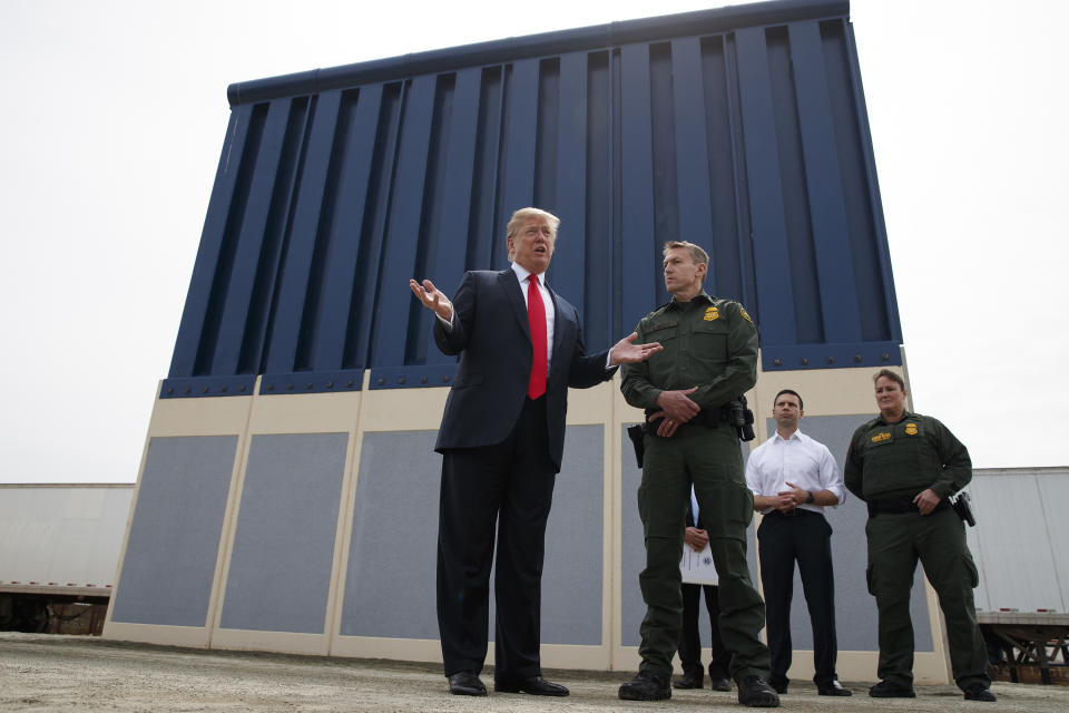 FILE - In this March 13, 2018, file photo, President Donald Trump talks with reporters as he reviews border wall prototypes in San Diego. California's attorney general filed a lawsuit Monday, Feb. 18, 2019, against Trump's emergency declaration to fund a wall on the U.S.-Mexico border. Xavier Becerra released a statement Monday saying 16 states — including California — allege the Trump administration's action violates the Constitution. (AP Photo/Evan Vucci, File)