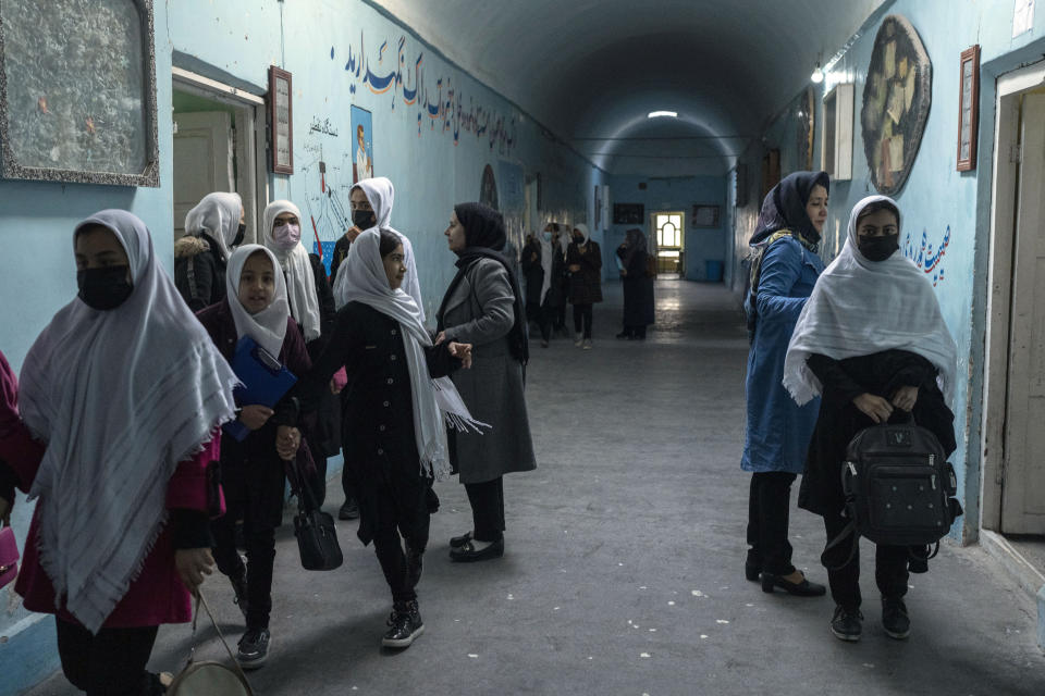 Afghan girls exit classrooms at Tajrobawai Girls High School, in Herat, Afghanistan, Thursday, Nov. 25, 2021. While most high school girls in Afghanistan are forbidden to attend class by the country's Taliban rulers, one major exception are those in the western province of Herat. For weeks, girls there have been attending high school classes, thanks to a unique effort by teachers and parents to persuade local Taliban administrators to allow schools to reopen. (AP Photo/Petros Giannakouris)