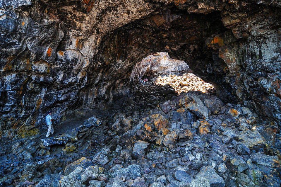 <strong>Length: </strong>1.6-mile (2.6-kilometer) loop and 1.8-mile (2.9-kilometer) loop<br /><br /><strong>Wow Factor: </strong>Scramble through lava tubes and around volcanic formations in one of the most inhospitable landscapes in the American West.<br /><br /><strong>Do It: </strong>Unlike classic stratovolcanoes, the lava rock fields and weird formations of&nbsp;<a href="https://www.nps.gov/crmo/index.htm" target="_blank">Craters of the Moon</a> formed when a rift tore open the earth: Magma oozed and erupted up in massive flows on the flat grasslands of the Snake River Plain. At the time, the Yellowstone hot spot&mdash;the massive, active volcanic caldera that makes up most of Yellowstone National Park&mdash;sat under this part of Idaho, and lava poured up from massive cracks, cooling into the same aa and pahoehoe rock being formed as lava cools in Hawaii today. The result is one of the most hostile playgrounds on the planet, a 400-square-mile (643.7-square-kilometer) labyrinth of cooled lava turned into tunnels and caves and rock that rips apart hiking boots. These two short hikes from the visitors center take you deep enough into this blasted, oddly beautiful wasteland of cinder cones and caves, some with year-round ice (permits are required to enter the caves).<br /><br /><strong>Don&rsquo;t: </strong>Wander too far off the trail. The lava formations create a maze that seems innocent from the outside but can be impossible to trace your way out of later. In 2013, two women who wandered off-trail here perished in the lava.