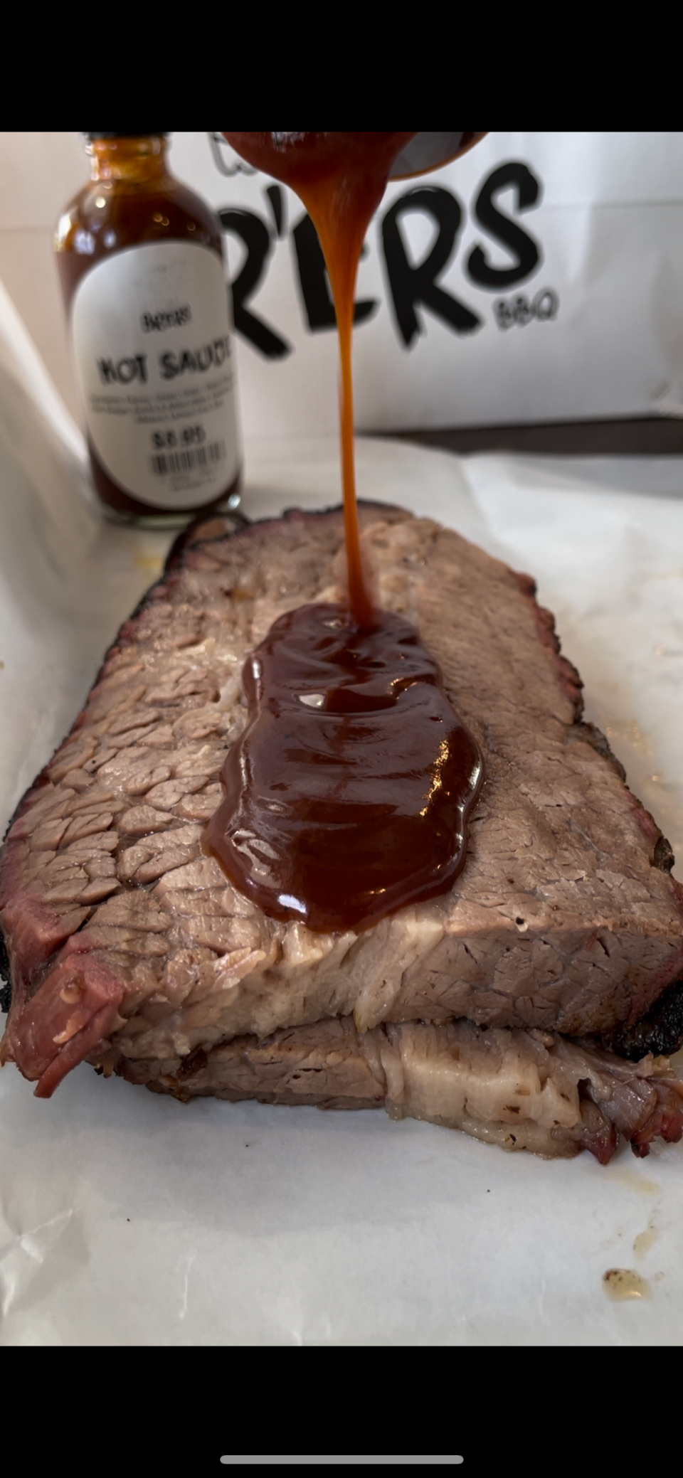 Pour on the sauce! All sauces are made in-house at Br’ers BBQ in Bedford Hills. Photographed April 2024