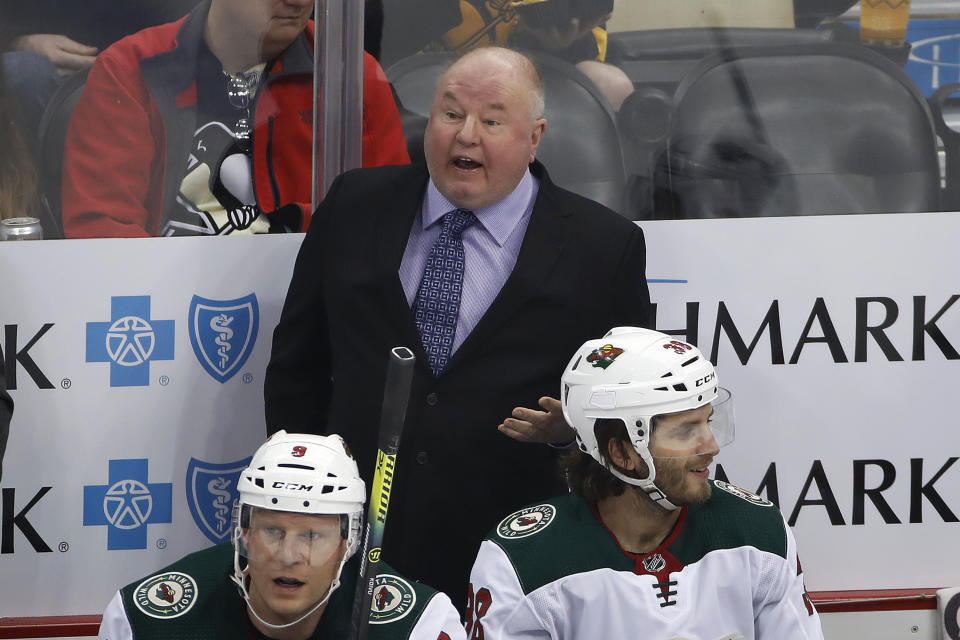 Minnesota Wild coach Bruce Boudreau stands behind the bench during the first period of the team;s NHL hockey game against the Pittsburgh Penguins in Pittsburgh, Tuesday, Jan. 14, 2020. (AP Photo/Gene J. Puskar)