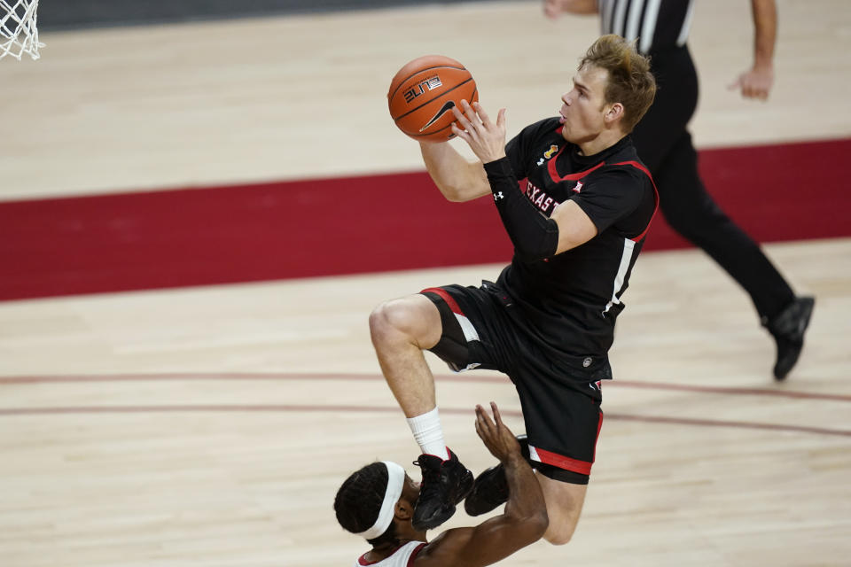Texas Tech guard Mac McClung, top, is fouled by Iowa State guard Tre Jackson while driving to the basket during the first half of an NCAA college basketball game, Saturday, Jan. 9, 2021, in Ames, Iowa. (AP Photo/Charlie Neibergall)