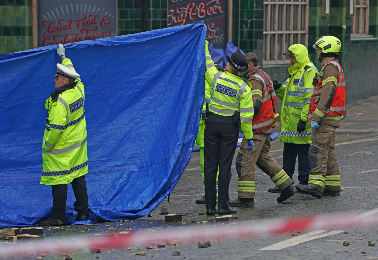 Emergency services at the scene on the Great Western Road, Notting Hill, west London, where three people have died after a vehicle collided with a residential block after a vehicle collided with a residential block. Picture date: Tuesday September 14, 2021.