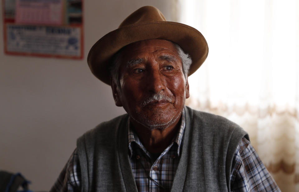 In this Sept. 13, 2019 photo, retired school teacher Gerardo Villca, a cousin of Bolivia's President Evo Morales, pauses during an interview in Orinoca, Bolivia. Rising in politics after leading a coca growers’ union, Morales became president in January 2006. In his more than 13 years in office, poverty has dropped steadily in South America’s poorest country. (AP Photo/Juan Karita)