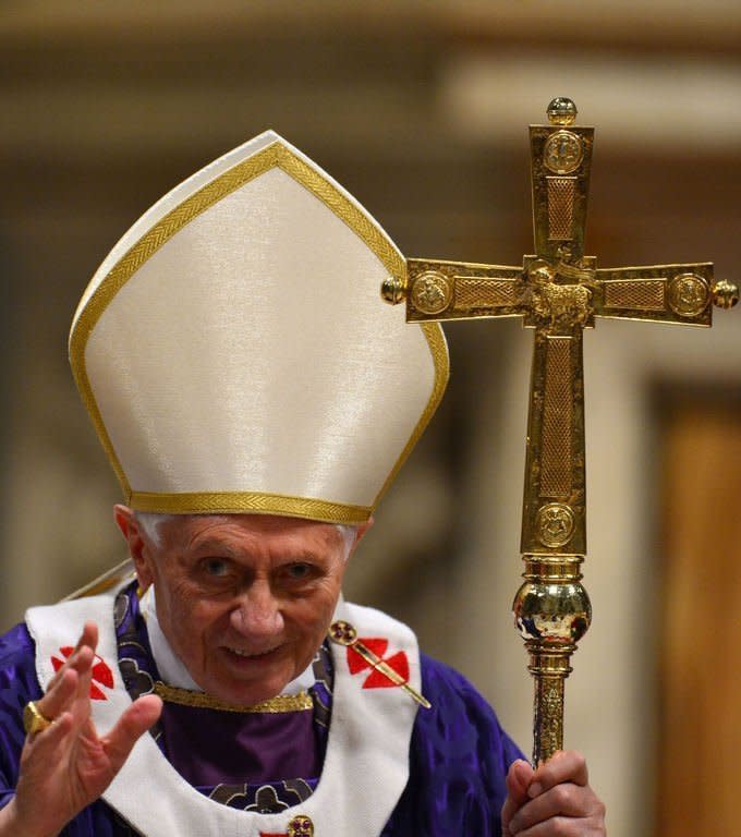 Pope Benedict XVI waves after celebrating Mass on February 13, 2013 at the Vatican