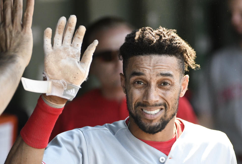 FILE - In this July 7, 2018, file photo, Cincinnati Reds' Billy Hamilton (6) is greeted in the dugout after scoring against the Chicago Cubs during the sixth inning of a baseball game, in Chicago. A person familiar with the negotiations says the Kansas City Royals and outfielder Billy Hamilton have agreed to a $5.25 million contract for next season that includes up to $1 million in incentives. The person spoke to The Associated Press on condition of anonymity Monday, Dec. 10, 2018, because the deal was pending a physical. The career .236 hitter's biggest attribute is his speed — he stole at least 50 bases four straight seasons before dipping to 34 last season. (AP Photo/David Banks, File)