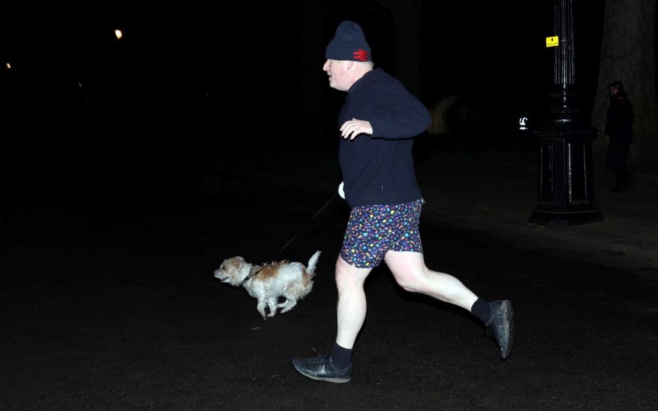Boris Johnson jogs with his dog Dilyn through St James's Park in London - Hannah McKay/Reuters